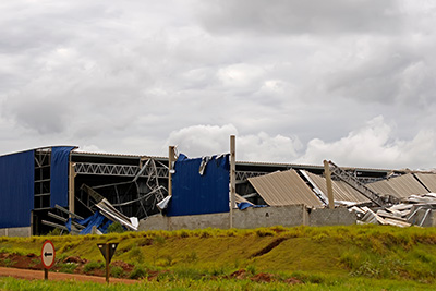 A collapsed metal building after a storm.