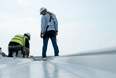 Workers repairing a commercial roof